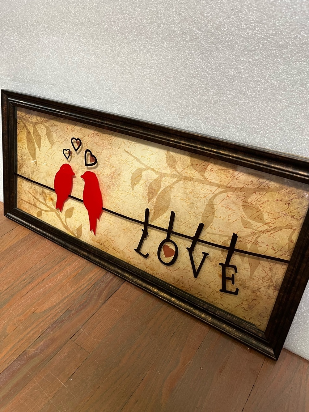 Red cardinal-style birds perched on a wire "LOVE" framed wall art